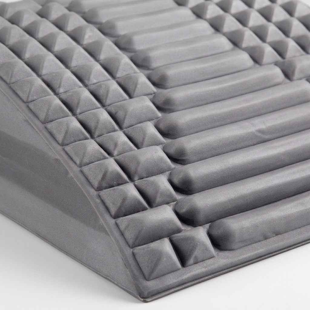 Close-up of the Crown Spinal Decompression Stretcher's ridge and nub texture along the arch edge