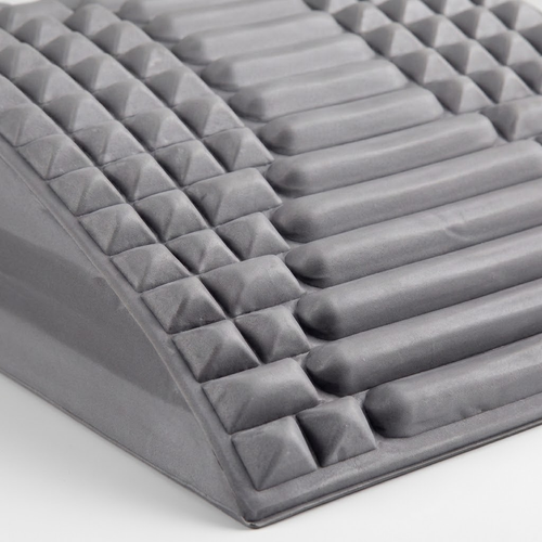 Close-up of the Crown Spinal Decompression Stretcher's ridge and nub texture along the arch edge